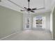 Bedroom featuring an exit to the pool, a tray ceiling, and carpeted flooring at 863 Macaw Cir, Venice, FL 34285