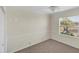 Bedroom with neutral carpet, paint and a ceiling fan and view at 863 Macaw Cir, Venice, FL 34285