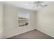 Bedroom features neutral carpet, paint and a ceiling fan with a view at 863 Macaw Cir, Venice, FL 34285