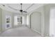 Open bedroom with tray ceiling, fan, and views of the pool through a sliding glass door at 863 Macaw Cir, Venice, FL 34285