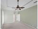 Spacious bedroom with tray ceiling, fan, and an attached ensuite bathroom and walk-in closet at 863 Macaw Cir, Venice, FL 34285