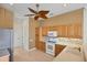 Bright kitchen features wooden cabinets, modern appliances, and a ceiling fan at 863 Macaw Cir, Venice, FL 34285