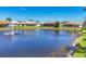 Beautiful lakefront homes with well-maintained lawns, complemented by a peaceful lake with a fountain at 863 Macaw Cir, Venice, FL 34285