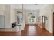 Bright, open-concept living room featuring hardwood floors, high ceilings, and decorative columns at 863 Macaw Cir, Venice, FL 34285