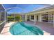 Covered lanai featuring a private pool, offering seamless indoor-outdoor living and water views at 863 Macaw Cir, Venice, FL 34285