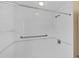 Clean and bright white tiled shower with grab bars and handheld showerhead at 863 Macaw Cir, Venice, FL 34285