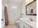 Cozy bathroom with tile floors, bath tub, and a framed mirror at 867 Macaw Cir, Venice, FL 34285
