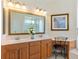 Double vanity bathroom with framed mirror and adjacent makeup vanity at 867 Macaw Cir, Venice, FL 34285