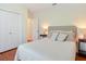 Bright bedroom featuring wood floors, neutral colors, and a comfortable bed and closet at 867 Macaw Cir, Venice, FL 34285