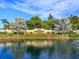 Community entrance with lush landscaping, water feature, and signature signage at 867 Macaw Cir, Venice, FL 34285