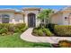 Inviting home entrance with a beautiful walkway and manicured greenery at 867 Macaw Cir, Venice, FL 34285
