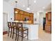 Kitchen with island bar, sleek pendant lighting, and attractive wood cabinetry at 867 Macaw Cir, Venice, FL 34285