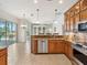 Kitchen featuring wood cabinetry, granite countertops, stainless steel appliances, and an open layout at 867 Macaw Cir, Venice, FL 34285