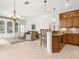 Open floorplan kitchen and living room boasting built-in shelving and granite countertops at 867 Macaw Cir, Venice, FL 34285