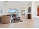 Bright living room featuring neutral walls and tile flooring with view to screened patio at 867 Macaw Cir, Venice, FL 34285