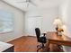 Home office with wood floors, a closet, and a writing desk at 867 Macaw Cir, Venice, FL 34285