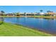 Scenic view of the pond, featuring a fountain and several homes in the background at 867 Macaw Cir, Venice, FL 34285