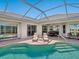Gorgeous pool with lounge chairs, an outdoor dining area, and an inviting patio at 867 Macaw Cir, Venice, FL 34285