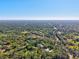 Expansive aerial view of wooded landscape, offering a glimpse of a serene property at 8902 Tropicaire Blvd, North Port, FL 34291