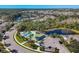 Aerial view of the community pool area, lush landscaping, and surrounding neighborhood, highlighting the prime location at 9312 Coachman Dr, Venice, FL 34293