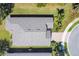 Aerial shot of a home's roof, driveway and landscaping from above at 9312 Coachman Dr, Venice, FL 34293