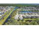 Expansive aerial of the community, showcasing the residential homes nestled amid serene lakes and lush green spaces at 9312 Coachman Dr, Venice, FL 34293