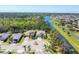 Neighborhood featuring attractive homes surrounding a landscaped cul-de-sac and a canal at 9312 Coachman Dr, Venice, FL 34293