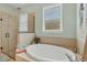 Bright bathroom with a soaking tub, walk-in shower, and window that provides natural light at 9312 Coachman Dr, Venice, FL 34293