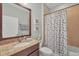 Cozy bathroom featuring granite countertops, a large mirror, and a bathtub with shower at 9312 Coachman Dr, Venice, FL 34293
