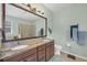 Bathroom features granite countertops, dual sinks, and a large mirror at 9312 Coachman Dr, Venice, FL 34293