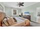 Comfortable bedroom featuring a wicker bed frame, soft bedding, and a desk for added comfort at 9312 Coachman Dr, Venice, FL 34293