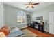 Stylish bedroom featuring hardwood floors, a stylish desk, and lots of natural light at 9312 Coachman Dr, Venice, FL 34293