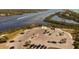 Aerial of a boat ramp featuring ample parking for vehicles and trailers, near a scenic waterway at 9312 Coachman Dr, Venice, FL 34293