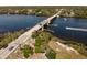 High angle view of a bridge over water, showcasing adjacent roads, boat docks, and surrounding landscape at 9312 Coachman Dr, Venice, FL 34293