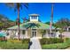 Inviting clubhouse featuring a green roof, lush landscaping, and a refreshing pool for residents to enjoy in a tropical setting at 9312 Coachman Dr, Venice, FL 34293