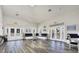 Bright and airy common room featuring stylish wood floors, comfortable seating, and an open layout with access to the pool area at 9312 Coachman Dr, Venice, FL 34293