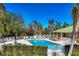 Relaxing community pool area featuring comfortable lounge chairs, lush landscaping, and shaded seating for residents enjoyment at 9312 Coachman Dr, Venice, FL 34293