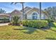 Charming home with a well-manicured lawn, mature landscaping, and an inviting facade for a welcoming curb appeal at 9312 Coachman Dr, Venice, FL 34293