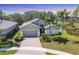 Charming single-story home featuring a brick driveway, attached garage, and well-maintained landscaping at 9312 Coachman Dr, Venice, FL 34293