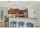 Open kitchen featuring a breakfast bar with seating, granite countertops and stainless steel appliances at 9312 Coachman Dr, Venice, FL 34293