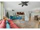 Open-concept living space featuring comfortable seating, decorative area rug and seamless flow to the kitchen at 9312 Coachman Dr, Venice, FL 34293