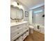 Modern bathroom featuring a bath and shower with a white vanity, and tiled walls at 937 Nettuno Dr, Venice, FL 34285
