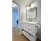 Bathroom with white vanity, gold fixtures, and modern square mirror at 937 Nettuno Dr, Venice, FL 34285