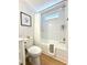 Updated bathroom with a shower-tub combo, white tile, and modern fixtures at 937 Nettuno Dr, Venice, FL 34285