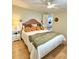 Bright bedroom featuring hardwood floors, stylish decor, and a ceiling fan at 937 Nettuno Dr, Venice, FL 34285