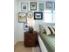 Stylish bedroom decor with gallery wall, green bedding, and oval wood nightstand at 937 Nettuno Dr, Venice, FL 34285