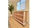 Charming bedroom dresser boasting a unique bamboo facade, creating a relaxing, coastal living space at 937 Nettuno Dr, Venice, FL 34285