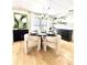Bright dining area with stylish decor, modern light fixture, and wood-look flooring at 937 Nettuno Dr, Venice, FL 34285