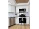Modern kitchen featuring stainless steel appliances, white cabinetry, and durable granite countertops at 937 Nettuno Dr, Venice, FL 34285