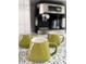 Kitchen detail showcasing granite countertops and green ceramic mugs at 937 Nettuno Dr, Venice, FL 34285